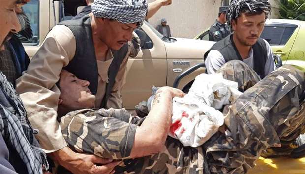 A wounded personnel of National Directorate of Security (NDS) is brought on a stretcher to a hospital after a car bomb exploded in the city of Aybak, in Samangan province