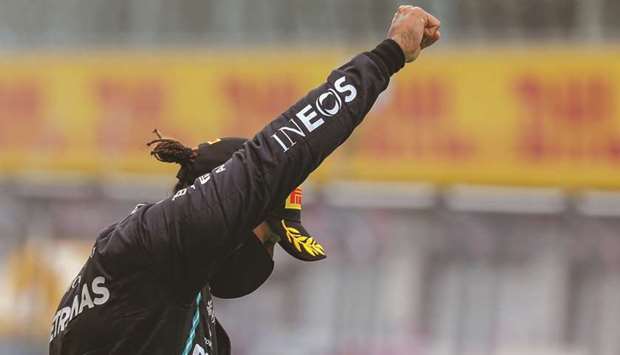 Mercedesu2019 British driver Lewis Hamilton raises a fist on the podium after winning the Styrian Grand Prix in Spielberg, Austria, yesterday. (AFP)