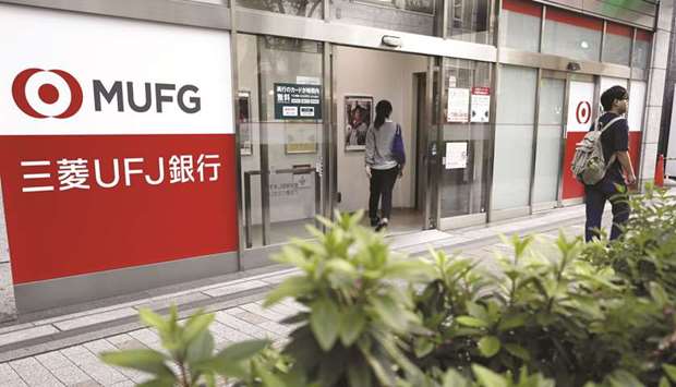 A customer enters a branch of MUFG Bank, a unit of Mitsubishi UFJ Financial Group Inc in Tokyo. The MUFG is seeking to spend money on startups like Grab Holdings Inc rather than purchase more brick-and-mortar financial institutions, chief executive officer Hironori Kamezawa said.