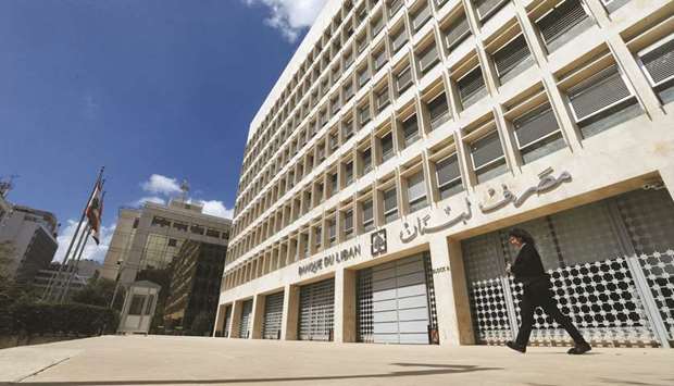 A woman walks outside of Lebanonu2019s central bank building in Beirut (file). The governmentu2019s rescue plan has served as the cornerstone of talks with the IMF and maps out massive losses in the financial system.