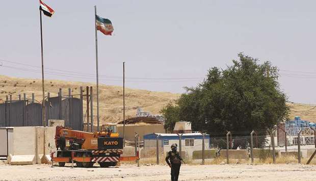 A member of Iraqi security forces stands guard on the Iraqi side of Mandali border crossing between Iraq and Iran on July 11. The regionu2019s economy will contract by 5.7% this year, and shrink by as much as 13% in countries torn by conflict, the Washington-based International Monetary Fund warned.
