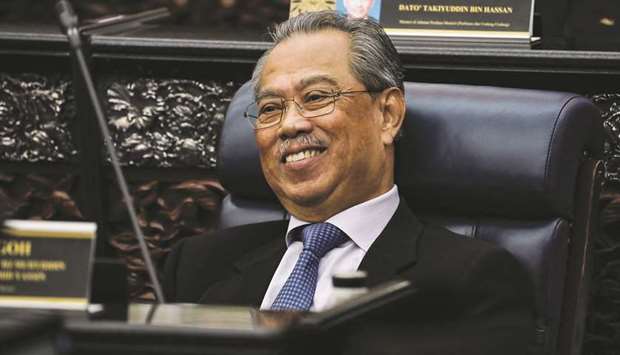Malaysiau2019s Prime Minister Muhyiddin Yassin smiles during a session of the lower house of parliament, in Kuala Lumpur yesterday.
