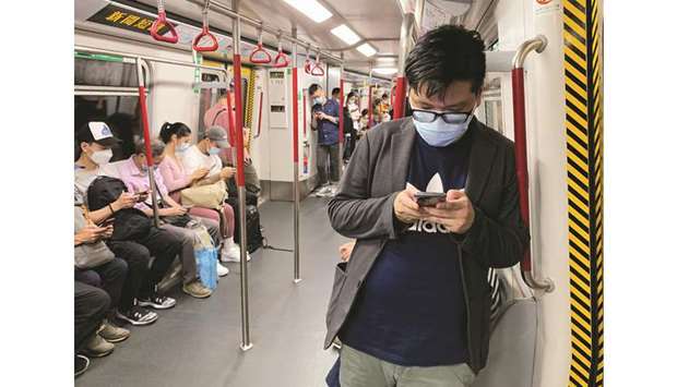 Passengers wear surgical masks in an MTR train, following the outbreak of the coronavirus (Covid-19) in Hong Kong yesterday.