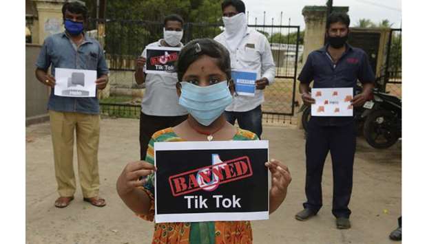 Members of the City Youth Organisation hold posters with the logos of Chinese apps in support of the government for banning the wildly popular video-sharing TikTok app, in Hyderabad yesterday.