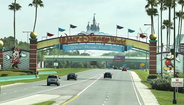 ALL ROADS LEAD TO DISNEY: Guests drive toward the entrance of Walt Disney Worldu2019s Magic Kingdom in Orlando, Florida. The theme park reopened at limited capacity during the coronavirus pandemic.