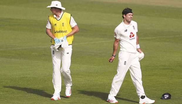 Englandu2019s Stuart Broad (L) acts as twelfth man and assists Englandu2019s James Anderson on the third day of the first Test cricket match between England and the West Indies at the Ageas Bowl in Southampton, southwest England on July 10, 2020. (AFP)