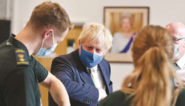 Prime Minister Boris Johnson gives an elbow bump greeting as he visits headquarters of the London Ambulance Service NHS Trust, amid the spread of the coronavirus disease, in London yesterday.