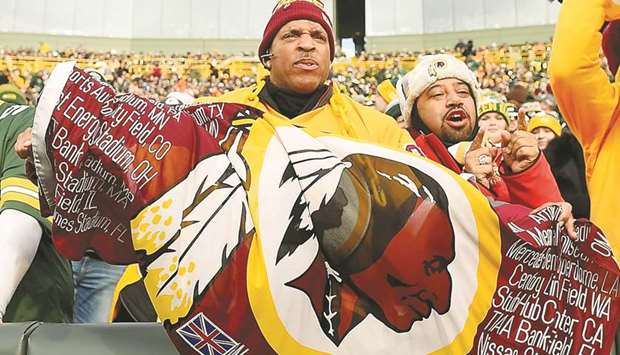 In this file photo taken on December 8, 2019, a Washington Redskins fan unfurls a flag during the game against the Green Bay Packers at Lambeau Field in Green Bay, Wisconsin. (AFP)