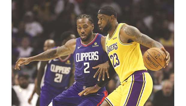LA Clippers forward Kawhi Leonard (left) guards Los Angeles Lakers forward LeBron James during a regular NBA game at Staples Center. (TNS)