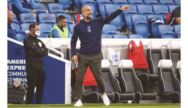 Manchester City manager Pep Guardiola gestures at his players during the English Premier League match against Brighton and Hove Albion at the The American Express Community Stadium in Brighton, United Kingdom, on Saturday. (Reuters)