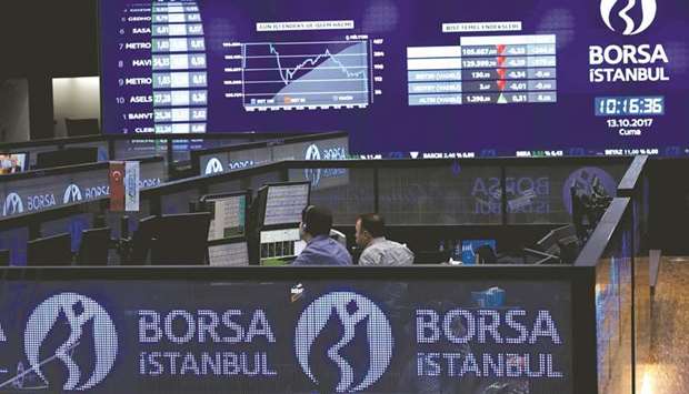 Traders work at their desks on the floor of the Borsa Istanbul in Istanbul (file). Turkeyu2019s market regulator fined seven brokerages for violating short-selling rules and imposed a six-month trading ban on individuals it suspects of stock-price manipulation through social-media platforms.