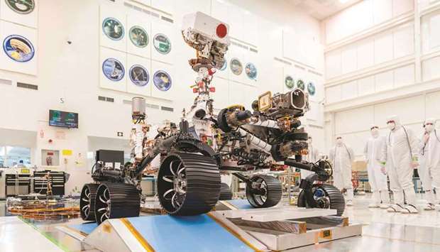 A handout photo, released by Nasa, of engineers in a clean room at the Jet Propulsion Laboratory in Pasadena, California, observe the first driving test for the Perseverance rover late last year.