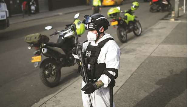 A military police officer using protective gear patrols in one of the neighbourhoods where the mayoru2019s office decreed strict quarantine, amidst an outbreak of the coronavirus disease, in Bogota, Colombia.