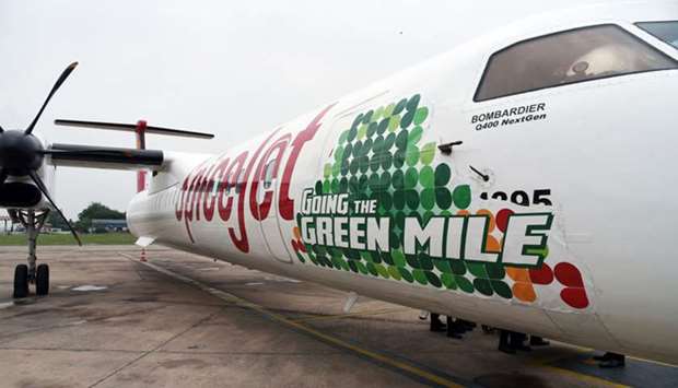 A Bombardier Q400 aircraft operated by SpiceJet stands at Indira Gandhi International Airport in Delhi, India, after completing its maiden flight using a blend of aviation fuel and oil from jatropha seeds, on August 27, 2018. Experts affirm post-Covid-19 u201cgreen recoveryu201d must embrace sustainable aviation fuels (SAF) in line with the aviation industryu2019s commitment to its emissions reduction goals.