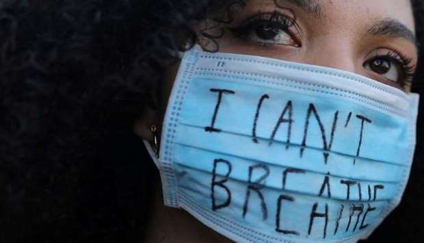 RESONANT CRY: A woman wearing a face mask with the words u201cI canu2019t breatheu201d looks on during a protest against the death in Minneapolis police custody of George Floyd, in front of a US consulate in Barcelona, Spain. u2014 Reuters