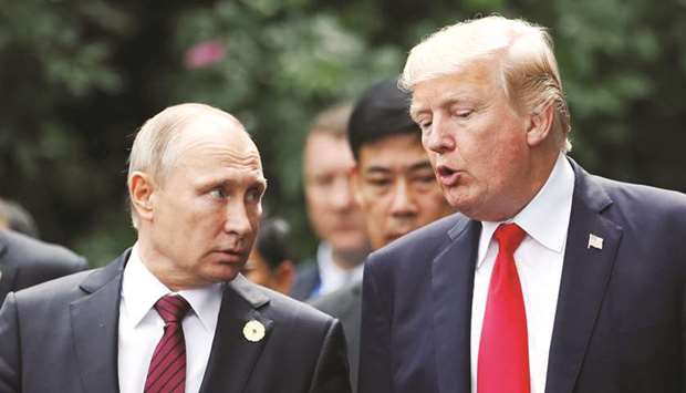 FILE PHOTO: US President Donald Trump and Russiau2019s President Vladimir Putin talk during the family photo session at the APEC Summit in Danang, Vietnam, on November 11, 2017.