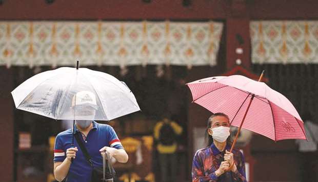 Visitors wearing protective face masks are seen amid the coronavirus outbreak, in Tokyo, yesterday.