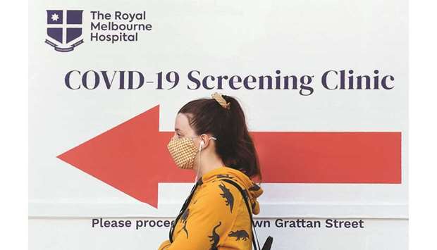 A woman queues outside a coronavirus testing venue at The Royal Melbourne Hospital in Melbourne yesterday.