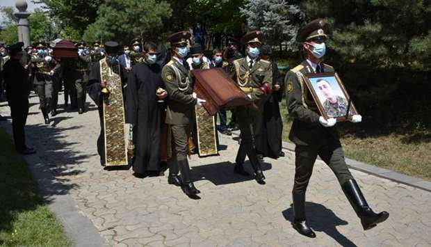 Armenian servicemen carry the coffin of Major Garush Hambardzumyan, who was killed during armed clashes on the Armenian-Azerbaijani border, during a funeral ceremony at Yerablur military pantheon in Yerevan yesterday