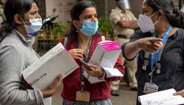 Lab workers from the Bangalore municipality Primary Health Centres (PHC) carry Rapid Antigen Covid-19 test kits to be used in containment zones after the city went into a new week-long lockdown from July 14 as number of Covid-19 coronavirus cases have surged, in Bangalore, India