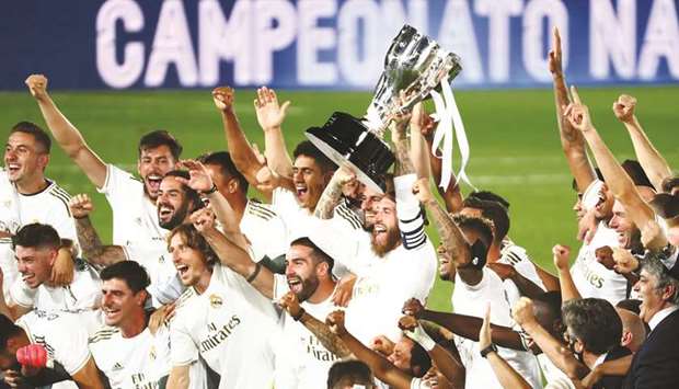 Real Madrid players celebrate with the trophy after winning the La Liga title at the Alfredo Di Stefano Stadium in Madrid. (Reuters)