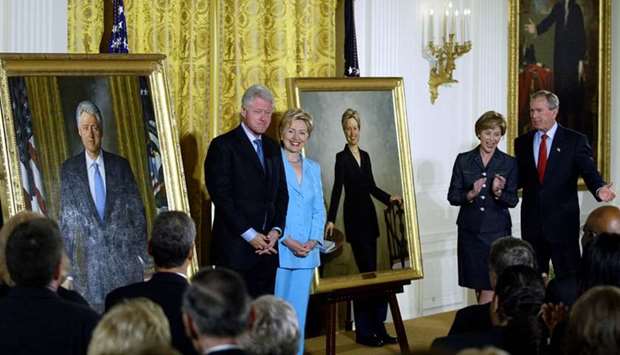 In this file photo taken on June 14, 2004 Former US President Bill Clinton (L) and Senator Hillary Clinton (2nd-L) stand by their offical White House portraits during the unveiling event hosted by President George W. Bush (R) and First Lady Laura Bush (2nd-R) in the East Room of the White House in Washington, DC.