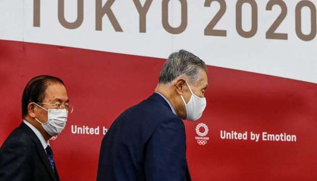 President of the Tokyo 2020 Organising Committee Yoshiro Mori (R), and Tokyo 2020 Organising Committee CEO Toshiro Muto, wearing face masks leave a news conference after giving a presentation to the International Olympic Committee (IOC) about the rearrangement of the Tokyo Summer Olympic Games for next year, in Tokyo on July 17.