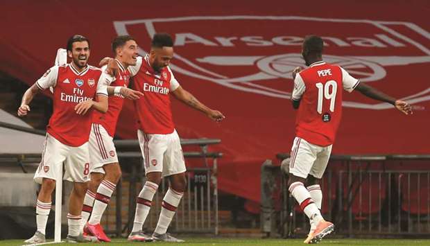 Arsenalu2019s striker Pierre-Emerick Aubameyang (third left) celebrates with teammates Nicolas Pepe (right), Dani Ceballos (left) and Hector Bellerin after scoring against Manchester City in the FA Cup semi-final at Wembley Stadium. (AFP)