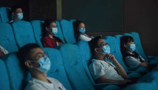 People watch a movie as they sit separately for social distancing at a cinema in Hangzhou in China's eastern Zhejiang province
