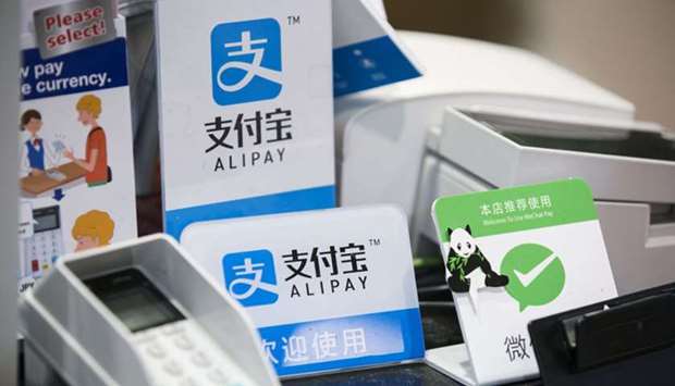 Signs for Ant Financial Services Groupu2019s Alipay are displayed at a shop in Tokyo. Ant Group is seeking a valuation of $200bn as it goes public in Hong Kong and Shanghai, people familiar with the matter said, kicking off a much-anticipated market debut for Chinau2019s leader in Internet finance.