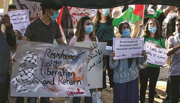 Mask-clad protesters (Covid-19 precaution) attend a demonstration against Israelu2019s plan to annex parts of the occupied West Bank, in the centre of the West Bank city of Ramallah, yesterday. Right: Hamas leader Yahya Sinwar (centre) takes part in a rally as Palestinians call for a u201cDay of Rageu201d to protest Israelu2019s plan to annex parts of the occupied West Bank, in Gaza City.