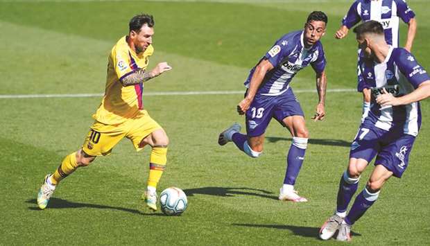 Barcelonau2019s Lionel Messi (left) in action during the La Liga match against Deportivo Alaves at Estadio Mendizorroza in Vitoria-Gasteiz, Spain, on Sunday. (Reuters)