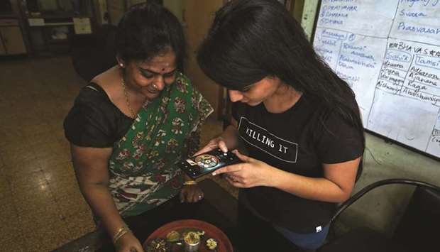 Geetha Sridhar makes a video on her miniature cooking with her daughter Sarada, that she said she will upload on an Indian app, after the government banned dozens of Chinese apps including TikTok, inside their house in Mumbai yesterday.