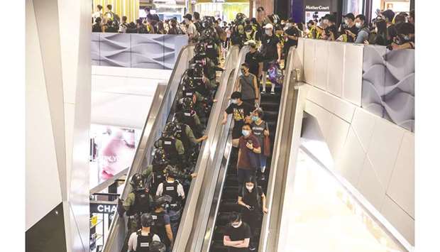 Riot police enter a shopping mall in Hong Kong.