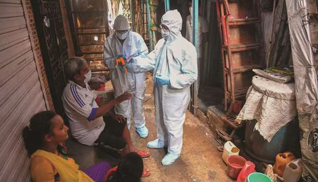 Medical staff conduct a door-to-door medical screening inside Dharavi slums to fight against the spread of the Covid-19.