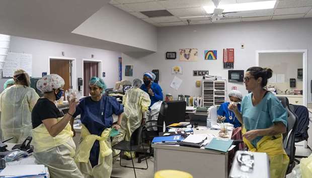 Medical staff gather in the Covid-19 intensive care unit at the United Memorial Medical Center, in Houston, Texas. Covid-19 cases and hospitalisations have spiked since Texas reopened, pushing intensive-care wards to full capacity and sparking concerns about a surge in fatalities as the virus spreads.
