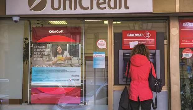 A customer uses an ATM at an UniCredit bank branch in Rome. UniCredit is in advanced talks with Illimity Bank SpA and Guber Banca SpA to offload about u20ac700mn of mostly unsecured non-performing corporate loans, according to people with knowledge of the matter.
