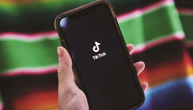 Signage for ByteDanceu2019s TikTok app is displayed on a smartphone in New Delhi.