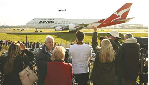 People watch as the last Qantas Boeing 747 airliner prepares to take off from Sydney airport to the US yesterday.
