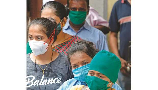 People who have recovered from coronavirus stand in a queue as they wait to donate blood plasma during a screening at a school in Dharavi, Mumbai, yesterday.