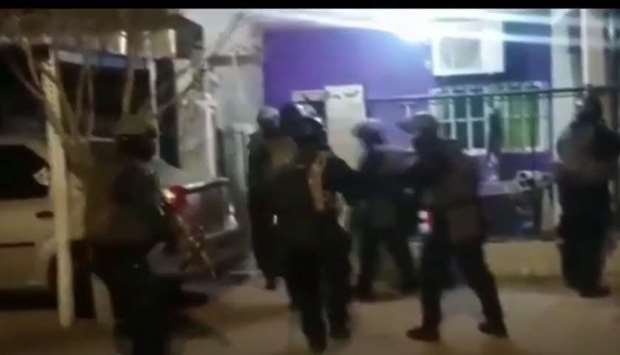 A screenshot from a video posted on  ilfattoquotidiano.it shows police conducting a raid