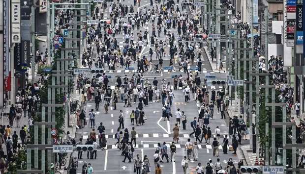 People walk on a street in Tokyo