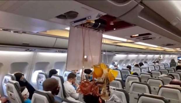 An image grab from a video released by state-run Iran Press news agency on July 24, reportedly shows released oxygen mask in the cabin of an Iranian passenger plane after it was intercepted by a US F-15 while flying over Syria. AFP