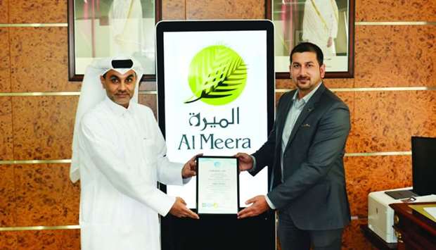 Al Meera officials with the ISO certification.