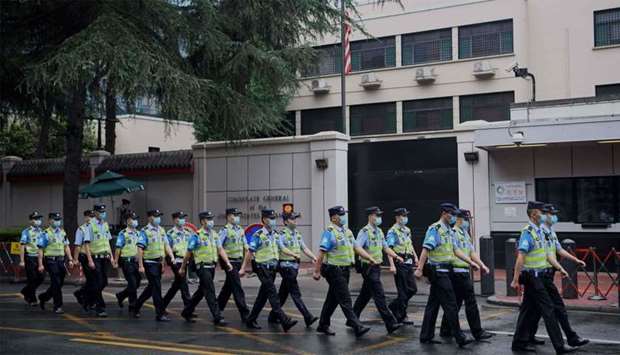 Policemen march past the US consulate in Chengdu, in Sichuan province