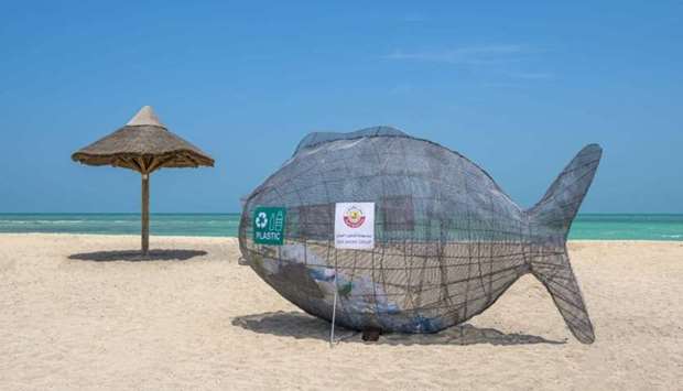 A garbage containers in the form of a fish.