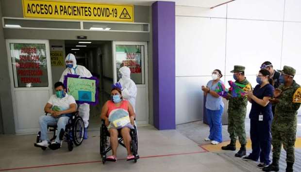 Patients who recovered from the coronavirus disease sit in wheelchairs after being released from the ,Tierra y Libertad, public hospital in Monterrey, Mexico on July 24.