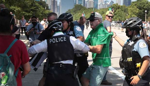 Police separate a pro-police demonstrator from counter-demonstrators during a Blue Lives Matter protest in Chicago, Illinois