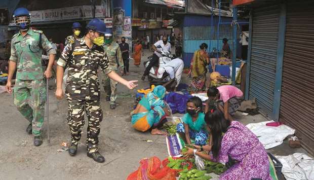 Police order sellers to clear a roadside market area during a lockdown imposed until July 29 as a preventive measure against the spread of the coronavirus in Siliguri, West Bengal yesterday.