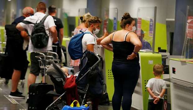 British tourists returning to UK, check in their luggage, as Britain imposed a two-week quarantine on all travellers arriving from Spain, following the coronavirus disease outbreak, at Gran Canaria Airport, on the island of Gran Canaria, Spain